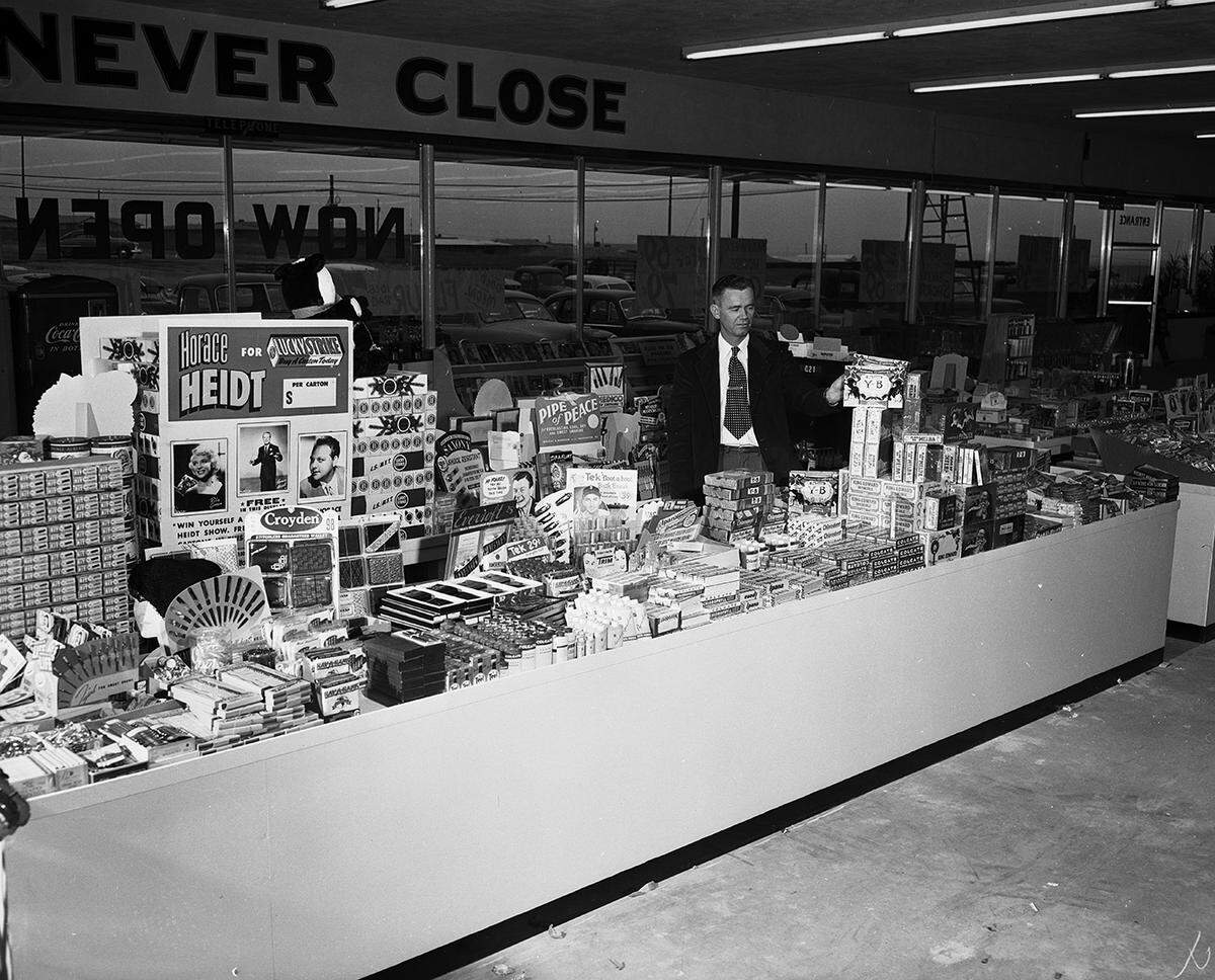 Dec. 18, 1952: Elton Simms, manager of the drugs and notions department of Buddie’s Super Market No. 3 at 6825 Camp Bowie, stands behind one of the many counters of the store devoted to drugs and notions.