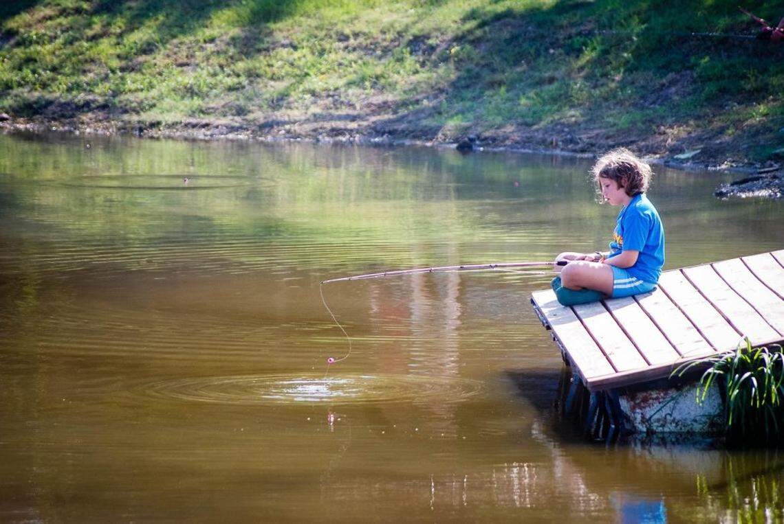 A guest fishing, one of the many activities you can do at Jellystone Park in Burleson, Texas.