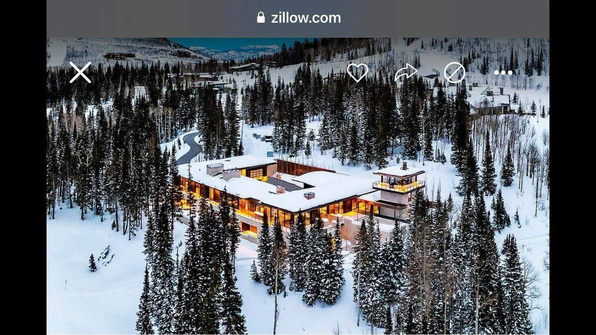 The mega mansion is surrounded by a winter wonderland.