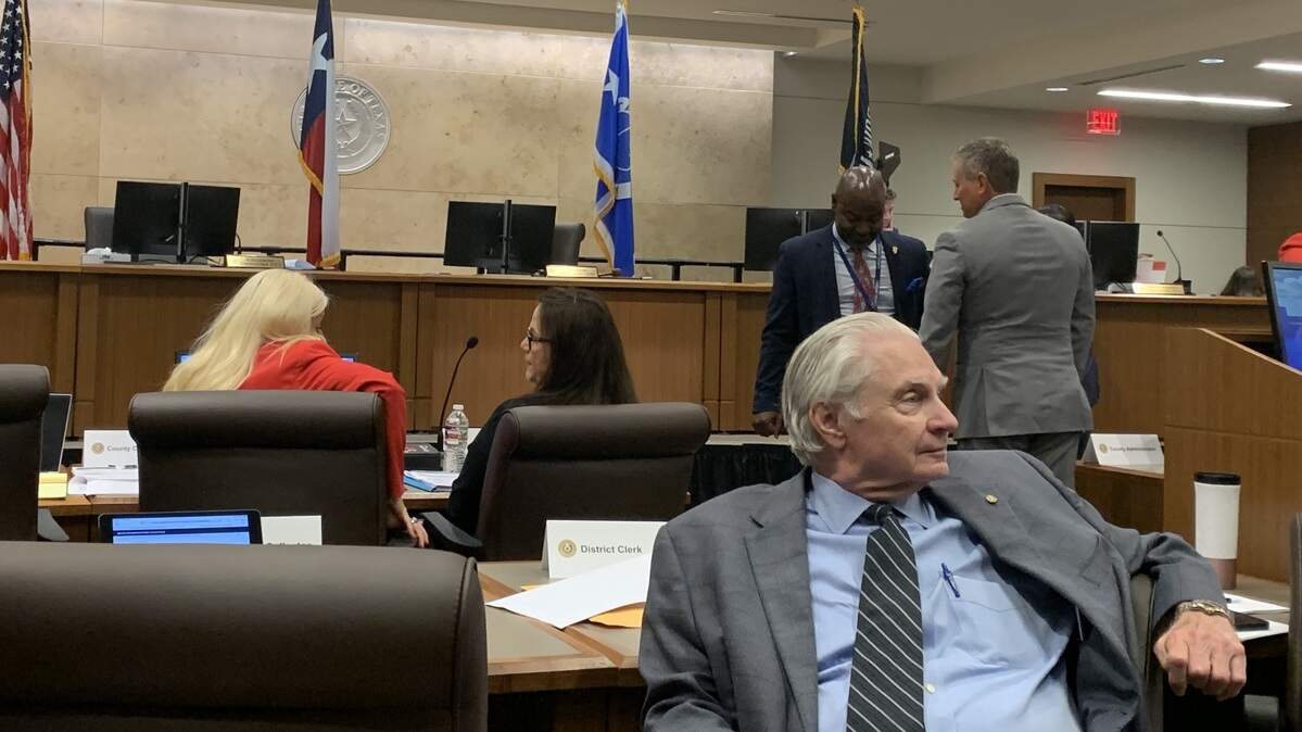 Tarrant County District Clerk Tom Wilder relaxes into his seat at the Aug. 5 county commissioners court meeting wherein the commissioners discussed hiring Attorney Tim Davis to represent Wilder in a case aiming to remove him from his role.