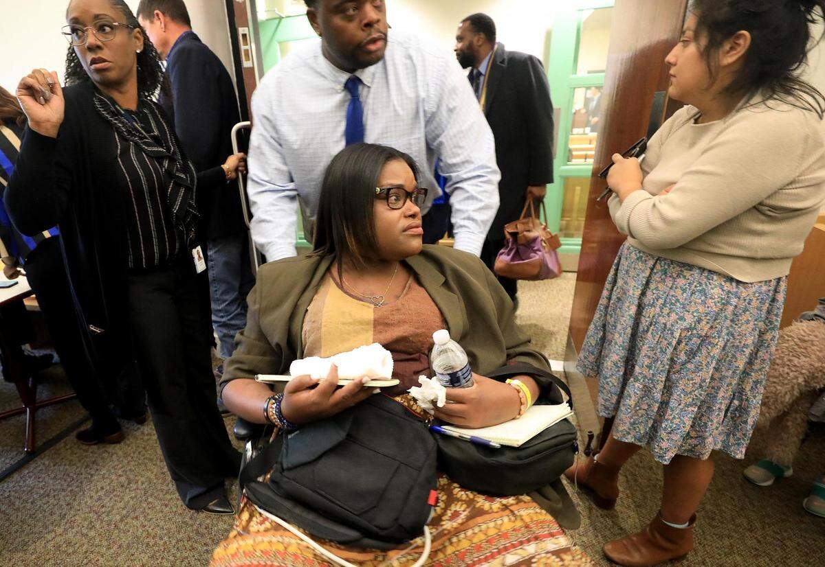 Amber Carr, center, leaves the courtroom after the first day of the murder trial of Aaron Dean, accused in the 2019 shooting death of her sister, Atatiana Jefferson, on Monday. Carr’s son, Zion, 11, testified about what he witnessed the night Jefferson was killed.