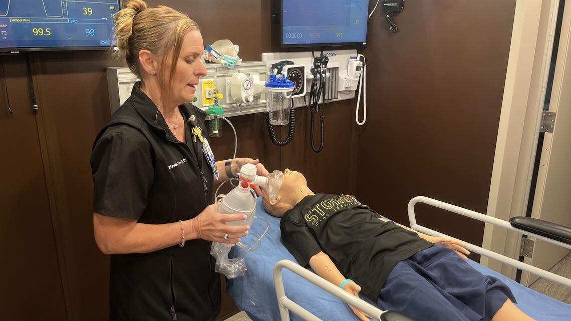 Rhonda Thompson, program manager for the Texas Health Resources mobile simulation training unit, demonstrates how a lifelike mannequin is used to train health care providers for a range of emergency scenarios.
