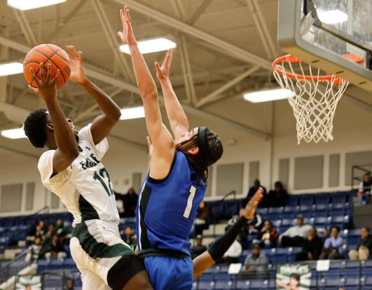 Lakeridge guard Abisayo Gbakinro (12) puts in for two over the arms of North Crowley guard Abram Hicks (1) during a UIL boys basketball game at Lake Ridge High School in Mansfield, Texas, Friday, Jan. 24, 2025.