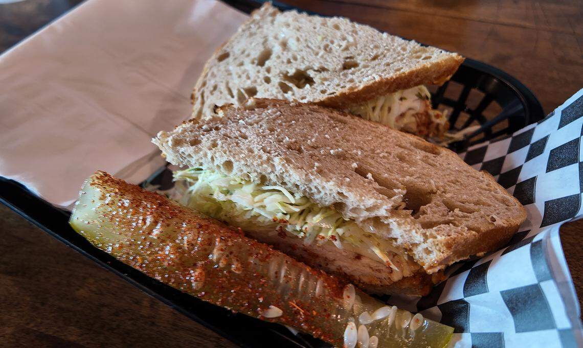 The Spicy Sour Boule at Sour Boule cafe in Fort Worth. The sandwich has chipotle mayo, layered with chipotle chicken, pepperjack cheese, tomatoes and pickle marinated slaw, all hugged by a plain piece of sourdough.