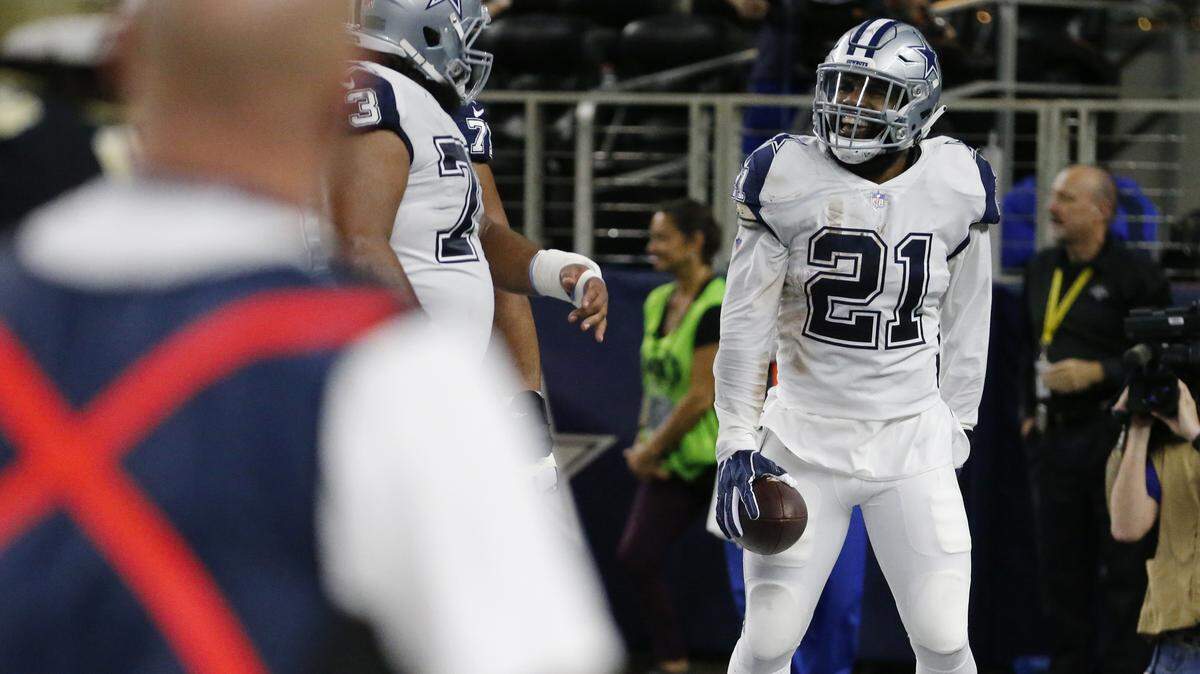 Dallas Cowboys running back Ezekiel Elliott (21) celebrates his touchdown against the New Orleans Saints in the first half of an NFL football game, in Arlington, Texas, Thursday, Nov. 29, 2018.