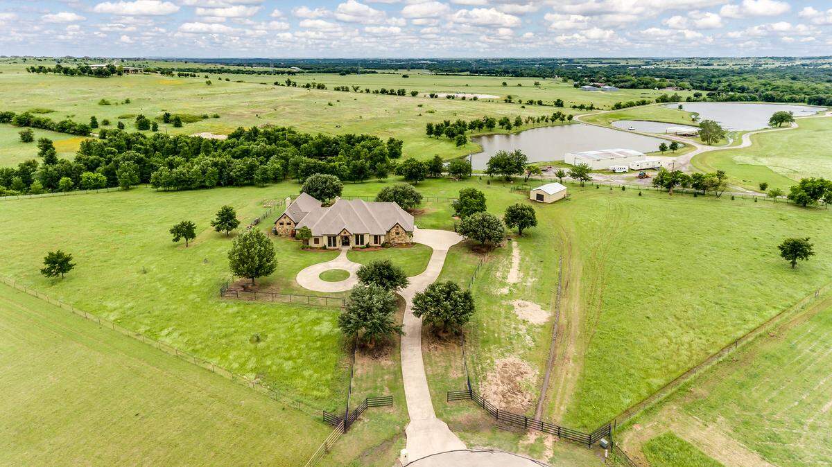 The home at 369 Aledo Springs Court is situated on over six and one-half fenced acres. 