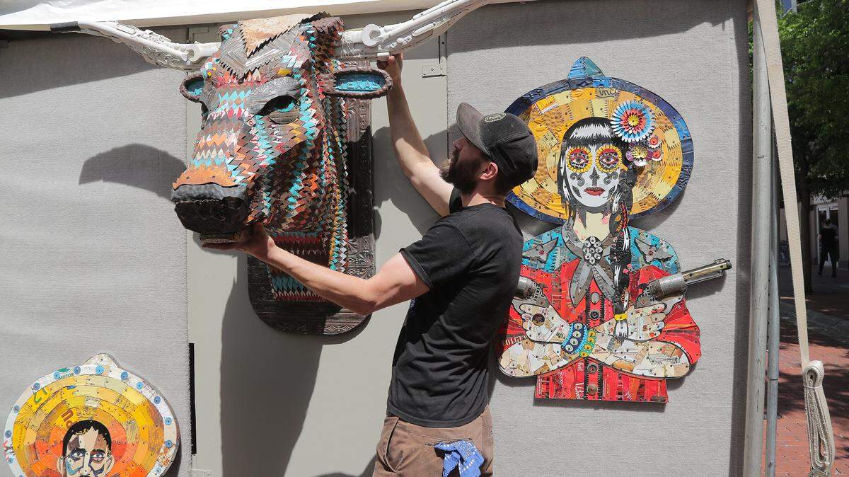 Artist Dolan Geiman of Denver readies his sculptures and collages = made from reclaimed materials - in preparation for a past Main St. Arts Festival. The festival returns April 7 downtown.