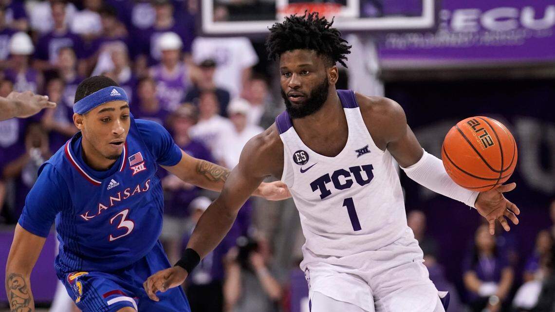 Kansas guard Dajuan Harris Jr. (3) defends as TCU guard Mike Miles (1) works up court in the second half of an NCAA college basketball game in Fort Worth, Texas, Tuesday, March 1, 2022. (AP Photo/Tony Gutierrez)