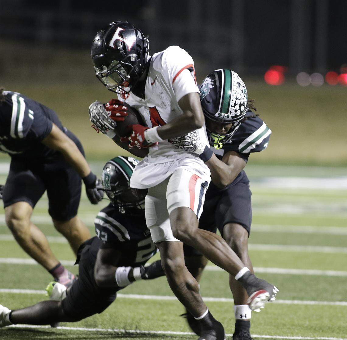 Euless Trinity running back Keondre Dixon (4) breaks a tackle against Mansfield Lake Ridge during their Class 6A Division I bi-district game on Friday, November 14, 2025 at Newsom Stadium in Mansfield Texas.