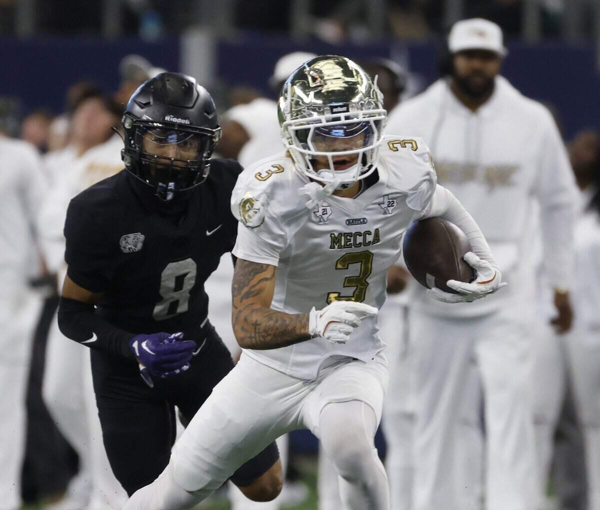 Dallas South Oak Cliff wide receiver Torrin Teague (3) takes it to the outside chased by Richmond Thomas Randle defensive back Julian Gerena (8) during the first half of the UIL Class 5A Division II championship game on Saturday Dec. 20, 2025 at AT&T Stadium in Arlington, Texas.