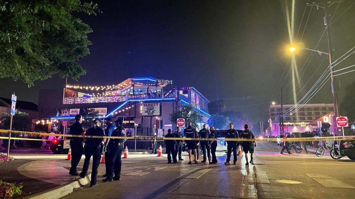 Fort Worth police at the scene of a May 2022 double shooting in the West Seventh district. Rising crime last year prompted an open container ban in November. The city on Tuesday unveiled more security measures in the wake of a TCU student's killing Sept. 1.