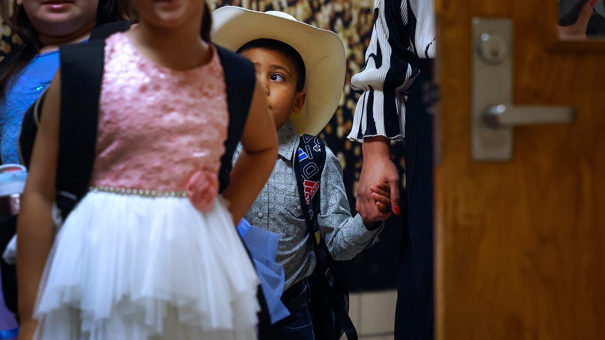 Joshua Reed, 5, waits in the hallway of M.H. Moore Elementary School to begin his first day of kindergarten on Tuesday.