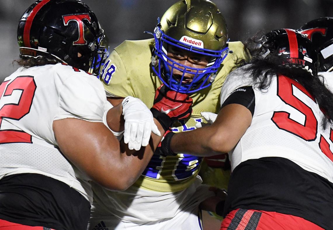 Boswell’s Jaedon Langley, center tries to get to the football as Trinity’s David Fiefia, left and Sio Lea’Aeatoa defend in the second quarter of Friday’s September 16, 2022 District 3-6A football game at Boswell High School Pioneer Stadium in Fort Worth, Texas. Special/Bob Haynes