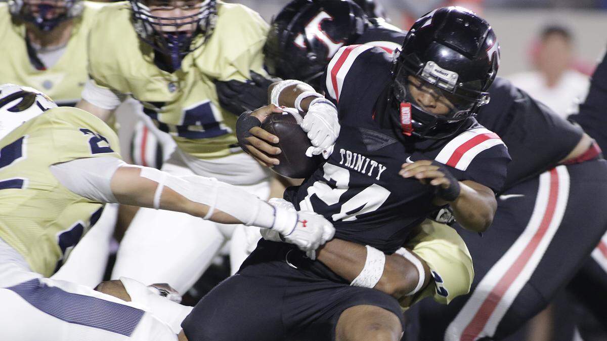 Euless Trinity running back JT Harris is brought down by the Keller defense during their game on Friday, October 17, 2025 at Pennington Field in Bedford, Texas. Harris rushed for 271 yards and four touchdowns.