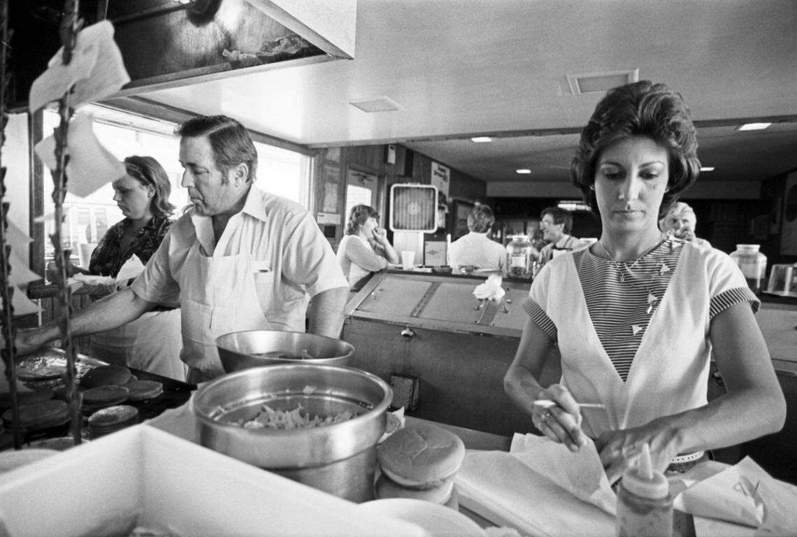 Oct. 5, 1983: Al Matthews cooks and prepares burgers at his restaurant, Al’s Drive-In, in Arlington as Raynell Scott helps wrap burgers. The restaurant has been family operated in Arlington since 1957. The location, 2121 N. Collins St., is now a Wal-Mart Neighborhood Market. The restaurant has moved twice and is now at 1276 N. Fielder Road.