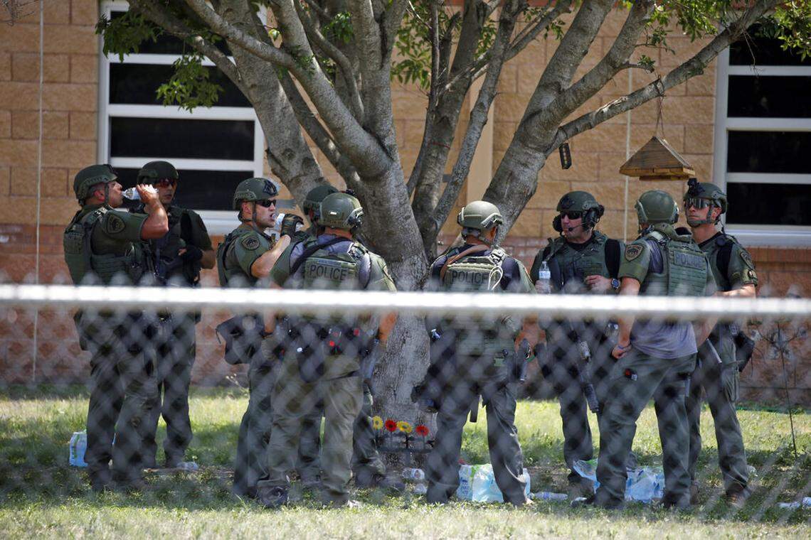 Law enforcement personnel stand outside Robb Elementary School following a shooting, Tuesday, May 24, 2022, in Uvalde, Texas. (AP Photo/Dario Lopez-Mills)