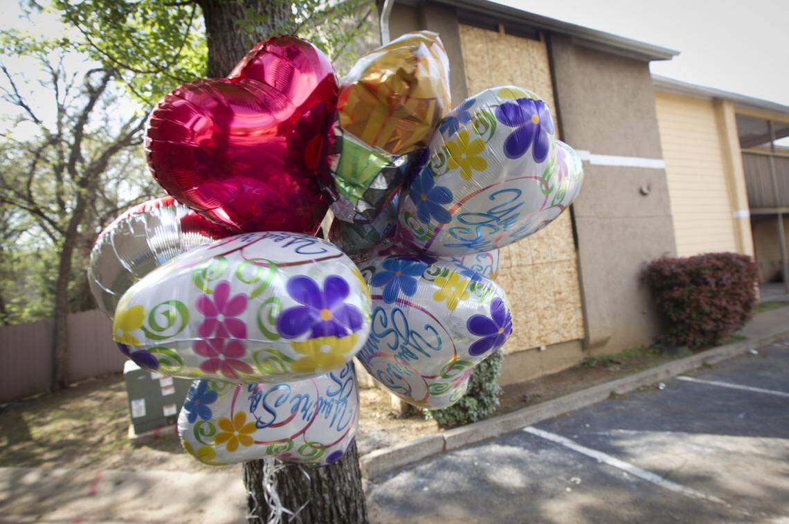 Memorials in front of the burned Arlington apartment two days after the murders of Mechelle Gandy, who was fatally stabbed, and her 1-year-old son.
