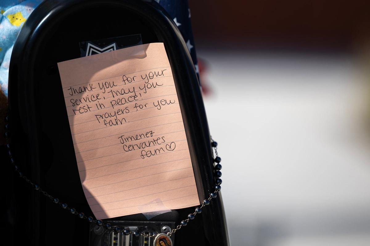 A handwritten message from the Jimenez and Cervantes family is placed on the patrol vehicle of the late Fort Worth Police Department Sgt. Billy Randolph at Fort Worth PD South Division headquarters in Fort Worth on Tuesday, Aug. 13, 2024. Sgt. Randolph was struck by a vehicle while working a crash scene on the exit ramp of IH-35W near Sycamore School Road Monday morning.