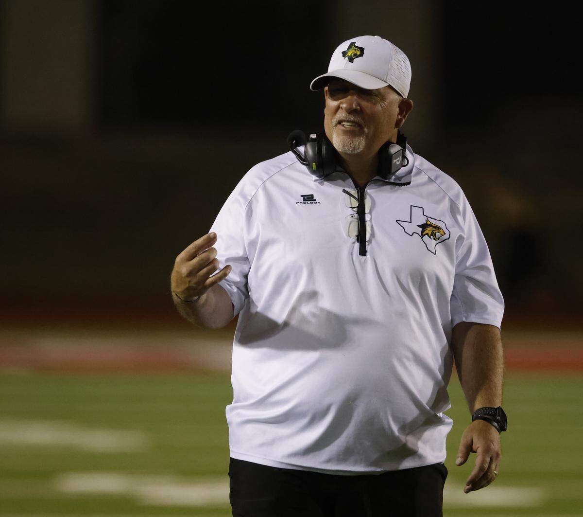 Benbrook head coach Cody Slater signals to his sideline during the first half of a UIL football game between Eagle Mountain and Benbrook at Farrington Field in Fort Worth, Texas, Friday, Sept. 26, 2025.