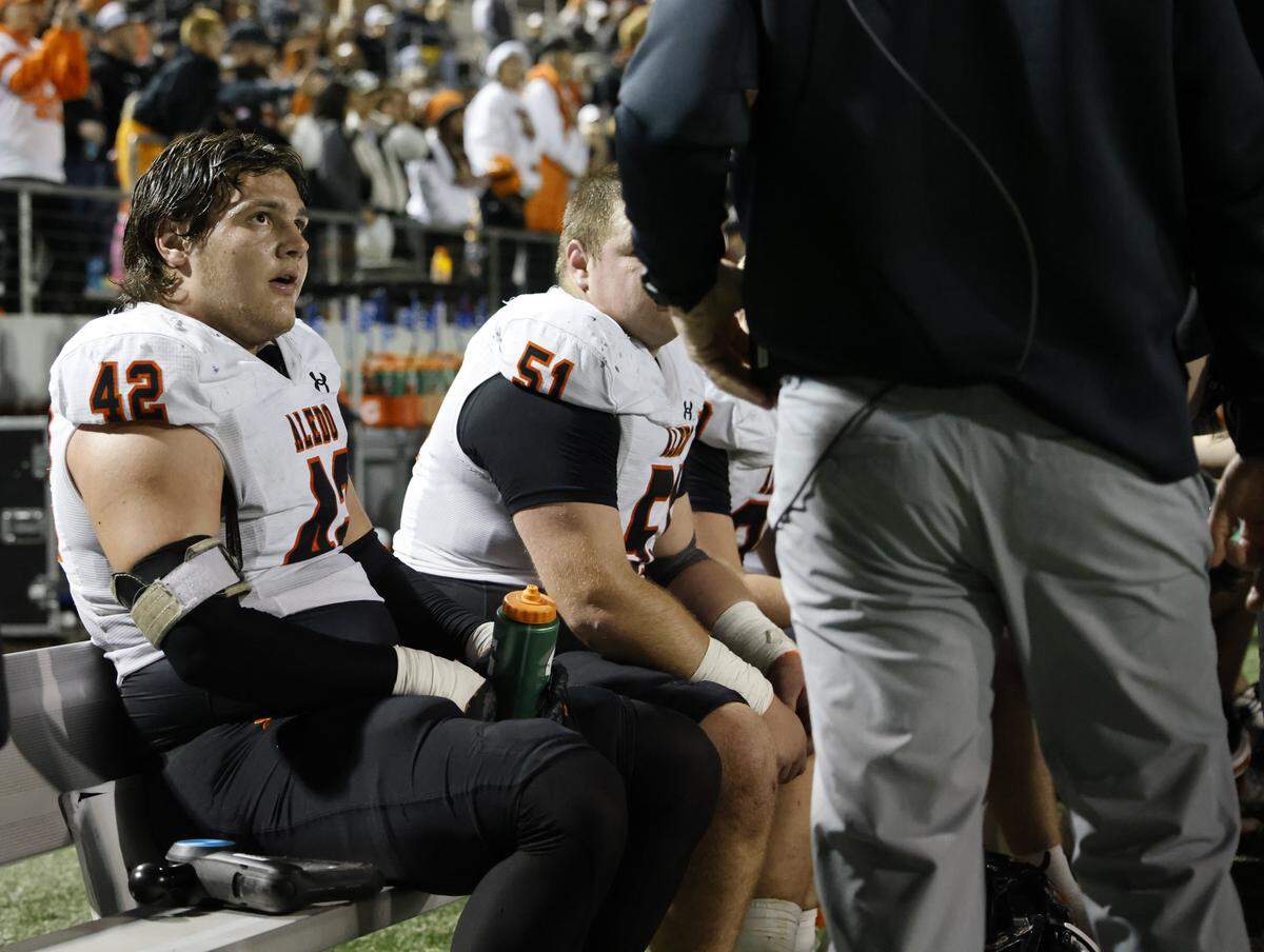 Aledo defensive end Cooper Cyphers (42) listens to assistant coach John Kirk during the second half against Frisco Lone Star in a Class 5A Division I state semifinal Friday at Newsom Stadium in Mansfield.