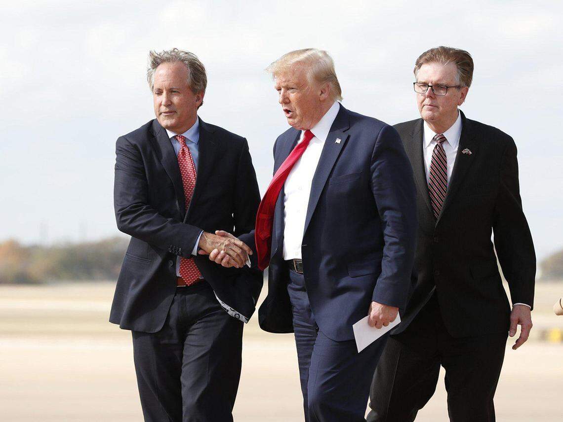 From left: Texas Attorney General Ken Paxton, President Donald Trump and Lt. Gov. Dan Patrick at Austin Bergstrom International Airport in November 2019. (Jay Janner/Austin American-Statesman/TNS)