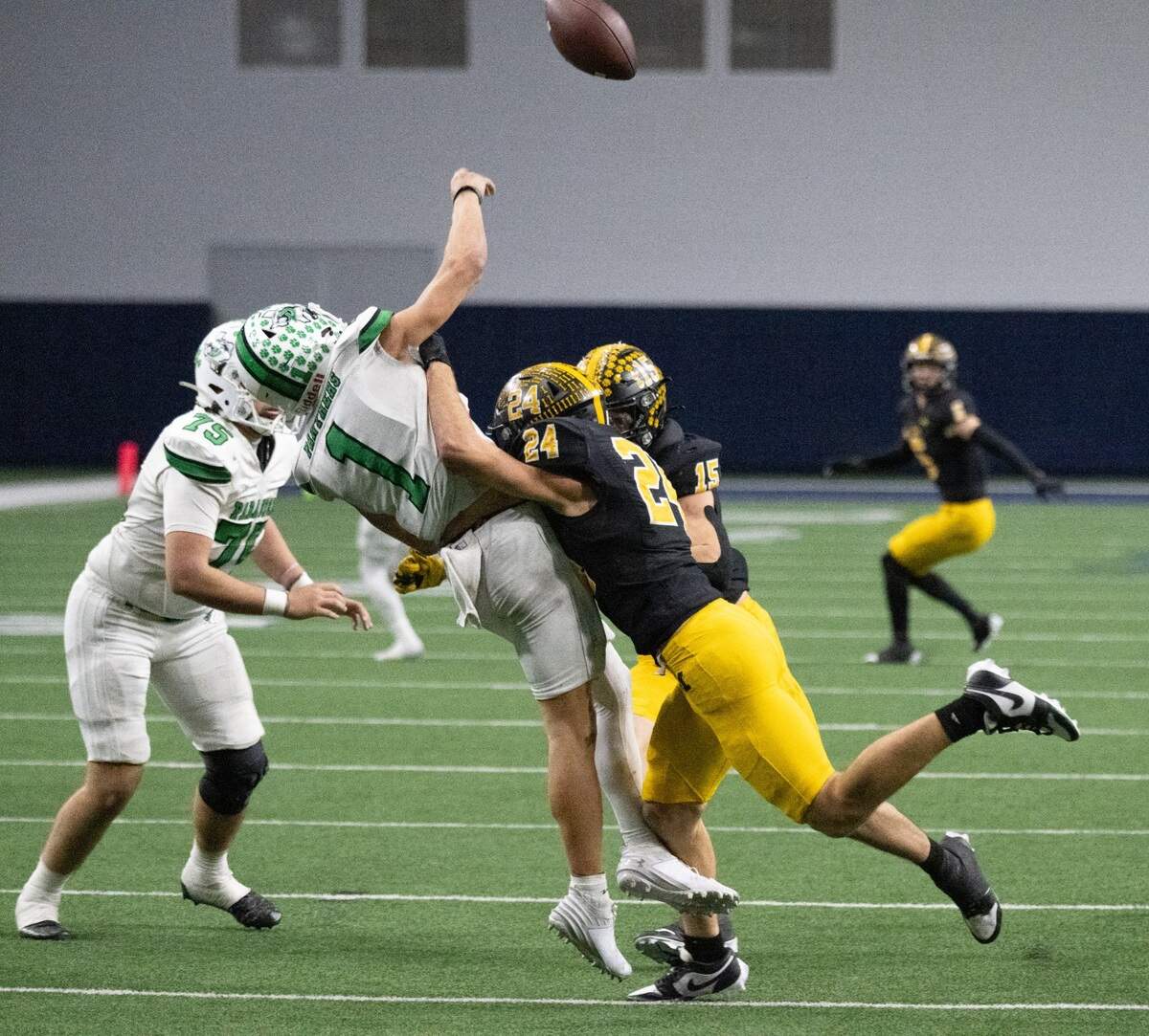 Malakoff linebacker James Studley (24) hits Paradise quarterback Ayden Winters (1) as he throws in a Class 3A Division 1 state quarterfinal on Thursday, Dec. 12, 2024 at the Ford Center in Frisco, Texas.