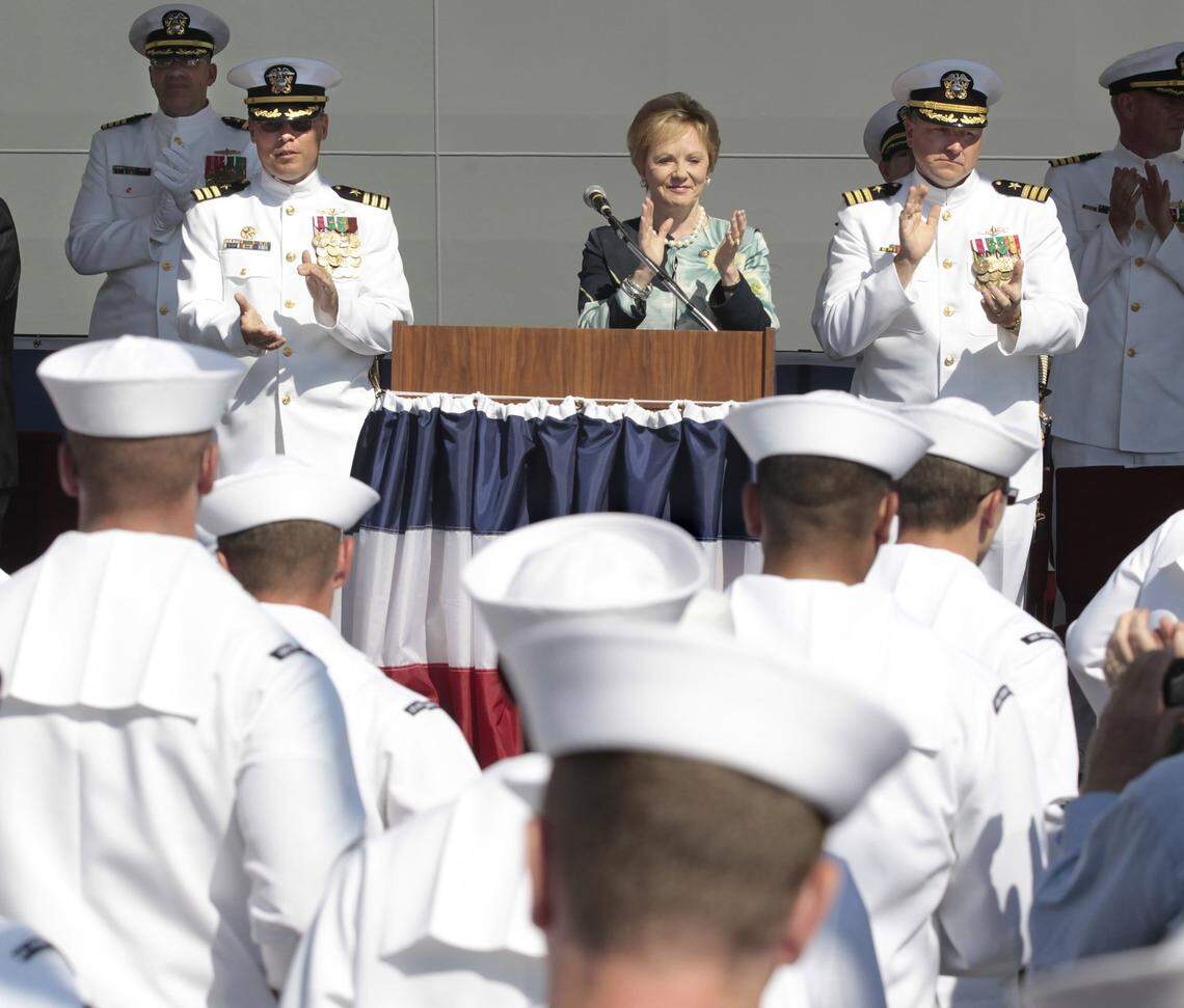Rep. Kay Granger and Commanders Randy Blankenship, left, and Warren Cupps applaud the arrival of the crew of the USS Fort Worth during its commissioning ceremony in Galveston, Texas, on Sept. 22, 2012.