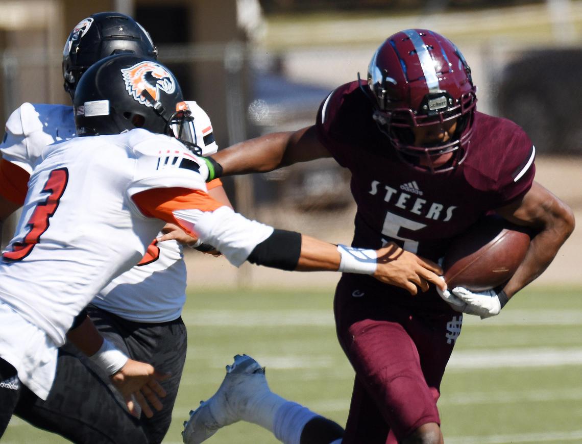 Polytechnic’s Akeil Smiley, left tries to reach North Side’s Da’Wain Lofton as he breaks away for a touchdown run to take a 21-20 lead in the fourth quarter during Saturday’s November 2, 2019 football game at Scarborough-Handley Field in Fort Worth, Texas. North Side went on to win 21-20. Special/Bob Haynes
