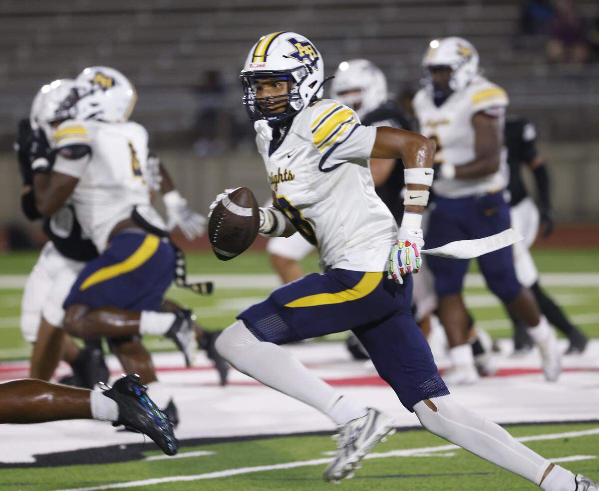 Arlington Heights defensive back Antonio Johnson (8) takes the ball upfield after intercepting South Hills quarterback Julian Calvillo (14) during the first half of a UIL football game between Arlington Heights and South Hills at Herman E. Clark Stadium in Fort Worth, Texas, Thursday, Sept. 18, 2025.