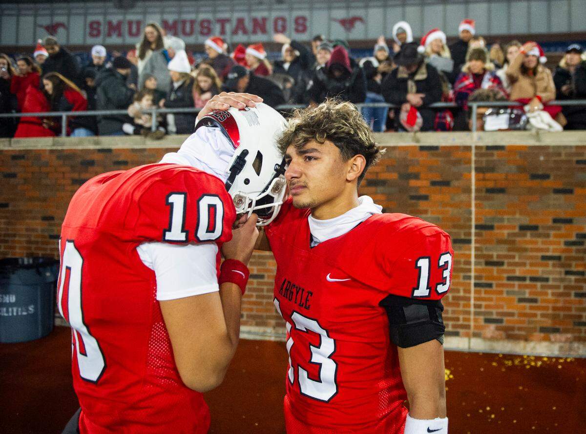 Argyle kicker Anthony Ruvalcaba (10) is consoled by wide receiver Jaxon Greene (13) after a losing to South Oak Cliff in a Class 5A Division II state semifinal on Friday, Dec. 13, 2024 at Gerald J. Ford Stadium in University Park, Texas.