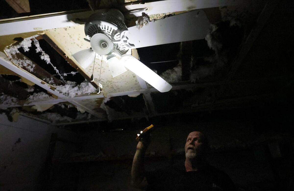 Rodney “Country” Jackson shines a light to show the damage to Eastside Ministries’ from fires in late November of 2023. A suspect has been arrested in charged with arson in the two fires.