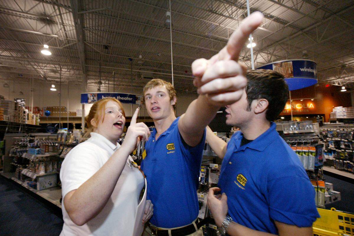 Nov 18, 2007: From left, Lacey Morris, Josh Smithers and Danny Prine along with all the employees at the Best Buy in Hurst, Texas, rehearse for Black Friday on the Sunday before.