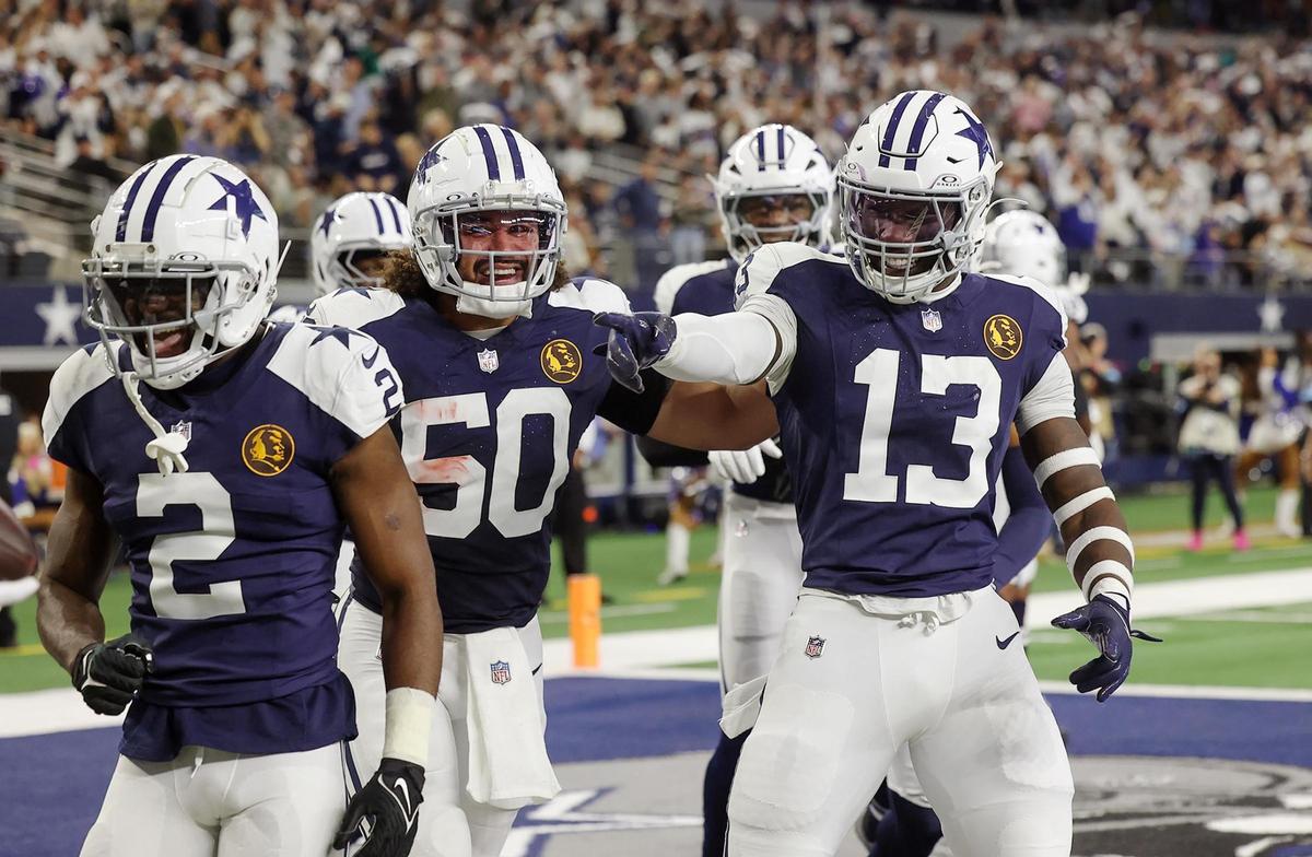 Dallas Cowboys linebacker DeMarvion Overshown (13) celebrates celebrates with teammates after scoring a touchdown on a recovered ball against the New York Giants on Thursday, Nov. 28, 2024, at AT&T Stadium in Arlington.