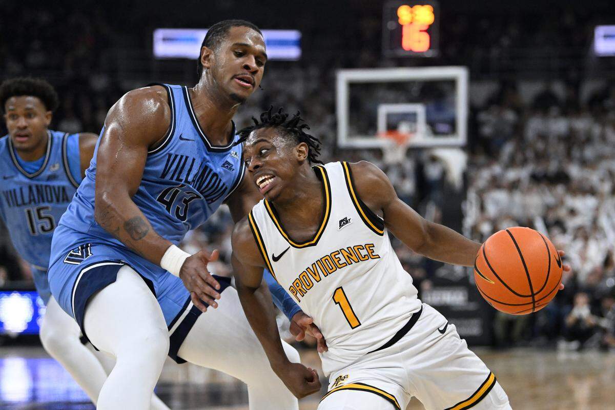 Feb 15, 2025; Providence, Rhode Island, USA; Providence Friars guard Jayden Pierre (1) drives the ball against Villanova Wildcats forward Eric Dixon (43) during the first half at Amica Mutual Pavilion. Mandatory Credit: Eric Canha-Imagn Images