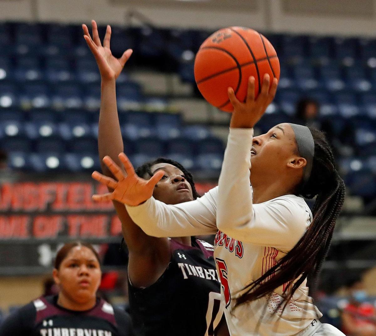 Legacy guard Savannah Catalon (5) puts in a left-hander against Timberview guard Stephanie Mosley (0) in the first half of a 8-5A district high school girls basketball game at Legacy High School in Mansfield, Texas, Friday, Jan. 22, 2021. The Lady Broncos led the Lady Wolves 22-11 at the half. (Special to the Star-Telegram Bob Booth)