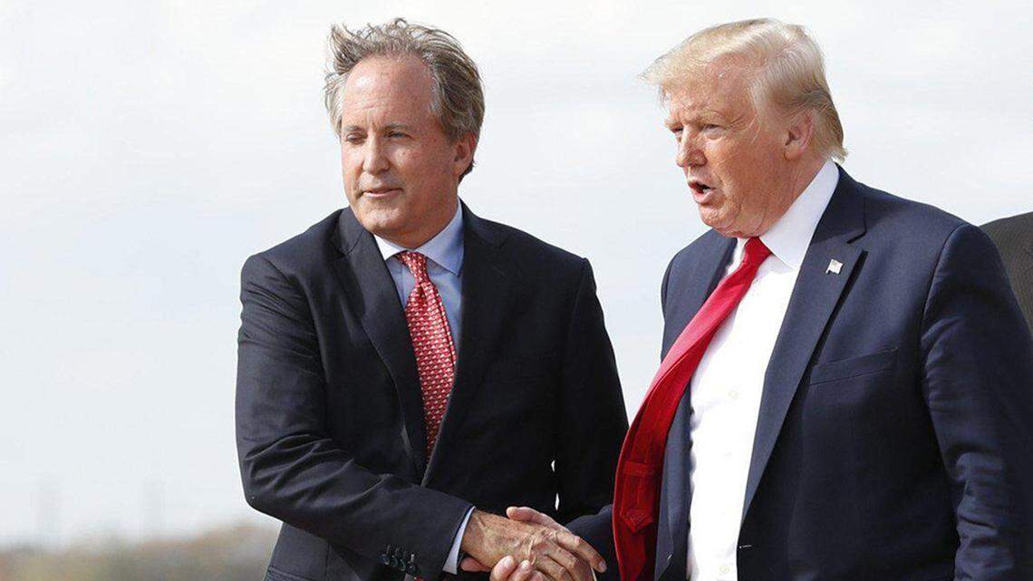 Texas Attorney General Ken Paxton, left, greeting President Donald Trump at Austin Bergstrom International Airport in November 2019. (Jay Janner/Austin American-Statesman/TNS)