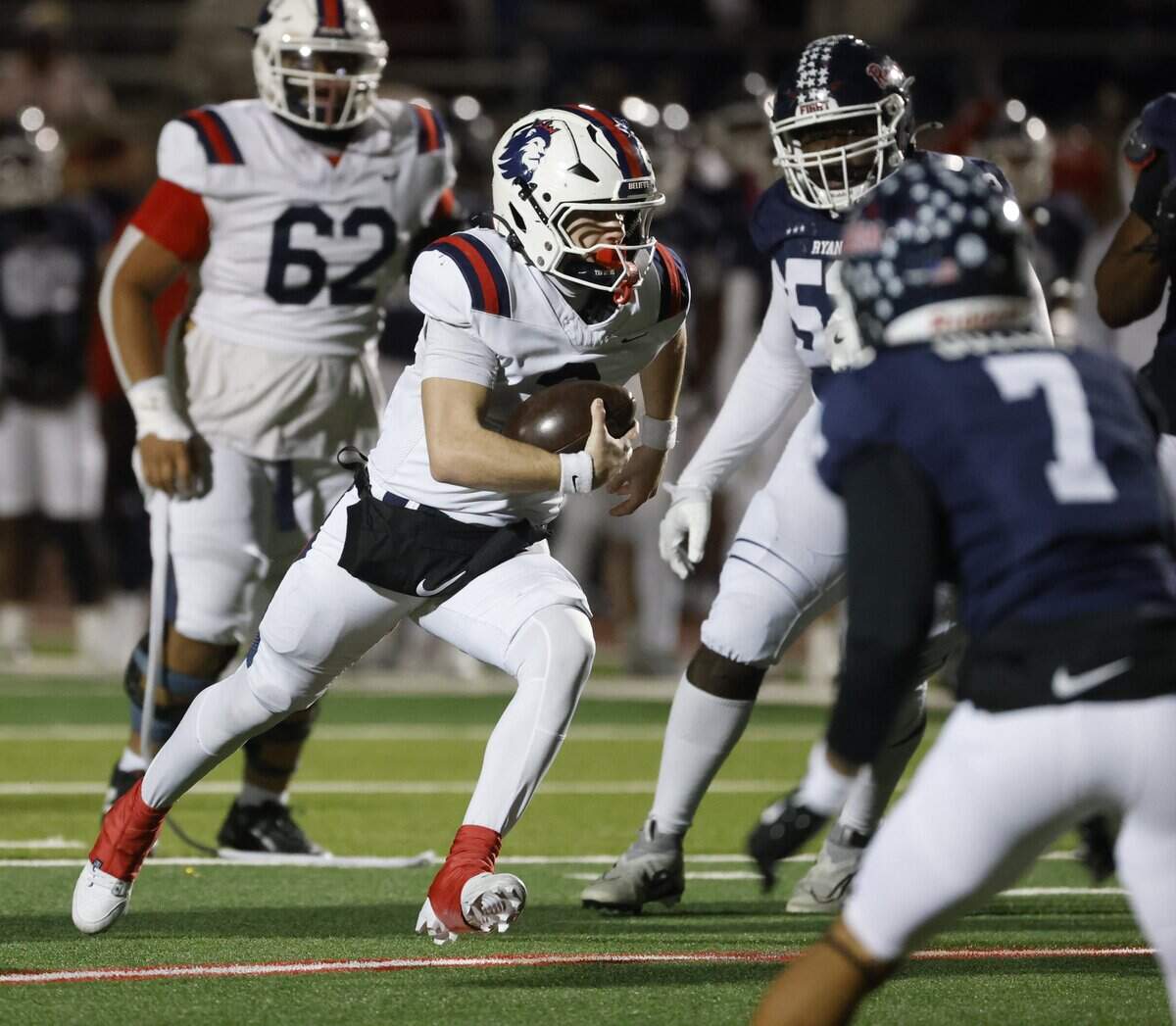 Richland quarterback Brett Kates (3) takes the ball up the middle against Denton Ryan during the first half of a UIL Class 5A Division I Regional on Friday Nov. 28, 2025 at Buddy Echols Field in Coppell, Texas.