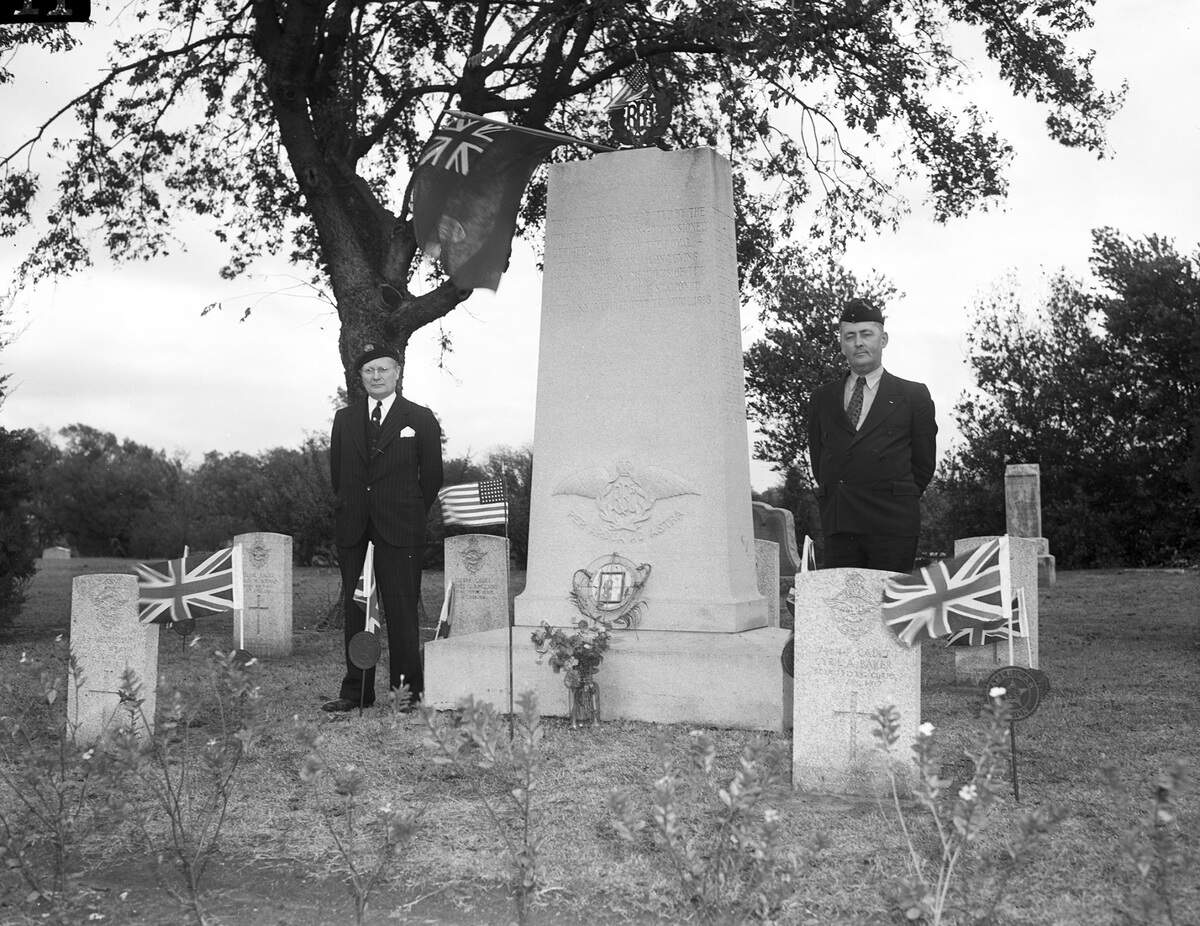 Nov. 11, 1940: Two Canadian armed forces veterans, George C. Fellows, left, and J.J. Connolly, stand next to a plot and where 11 members of the Canadian Royal Flying Corps are buried at Greenwood Cemetery in Fort Worth. They unfurled Union Jacks sent by the Daughters of the Empire, a women’s organization in Toronto. Fellow’s beret carries the emblem of the Canadian Corps and Connolly’s cap bears the emblem of the British Empire Service League.