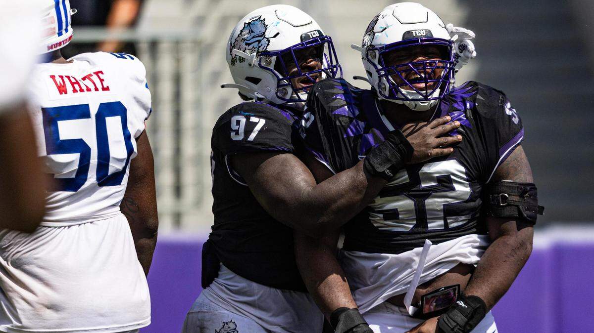 TCU defensive linemen Paul Oyewale (97) and Damonic Williams (52) celebrate after getting a sack to seal the game in the fourth quarter of a college football game between the TCU Horned Frogs and the SMU Mustangs at Amon G. Carter Stadium in Fort Worth on Saturday, Sept. 23, 2023.