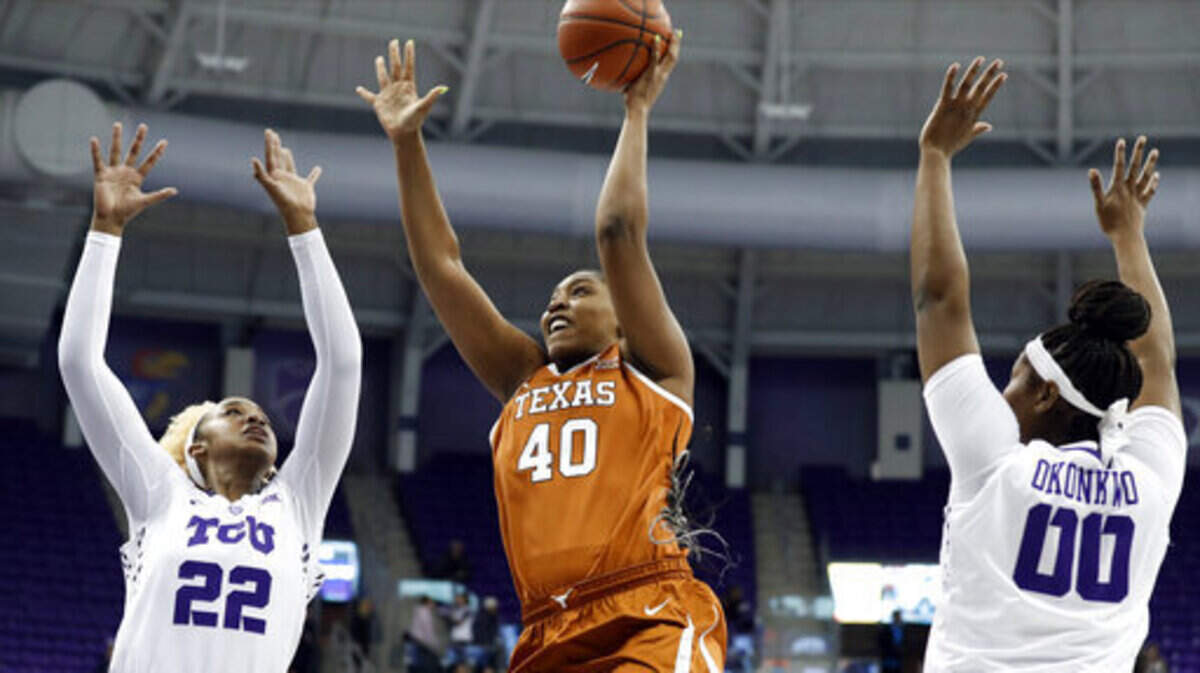 TCU’s Jordan Moore (22) and Amy Okonkwo (00) defend as Texas forward Jatarie White (40) shoots during the first half of an NCAA college basketball game in Fort Worth, Texas, Tuesday, March 5, 2019. (AP Photo/Tony Gutierrez)