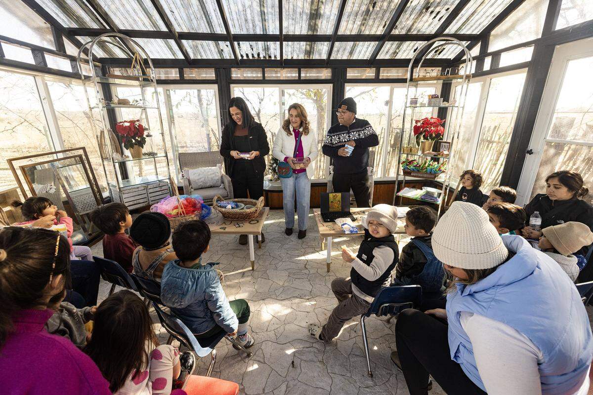 Founders Lizned Larrota, left,  Luzmiryam, center, and Luis Rojas speak to the class at the Curious Farm House in Godley on Wednesday, Dec. 10, 2025. The Curious Farmhouse is a nature-based, bilingual space where children learn farming, nutrition and hands-on skills through gardening.