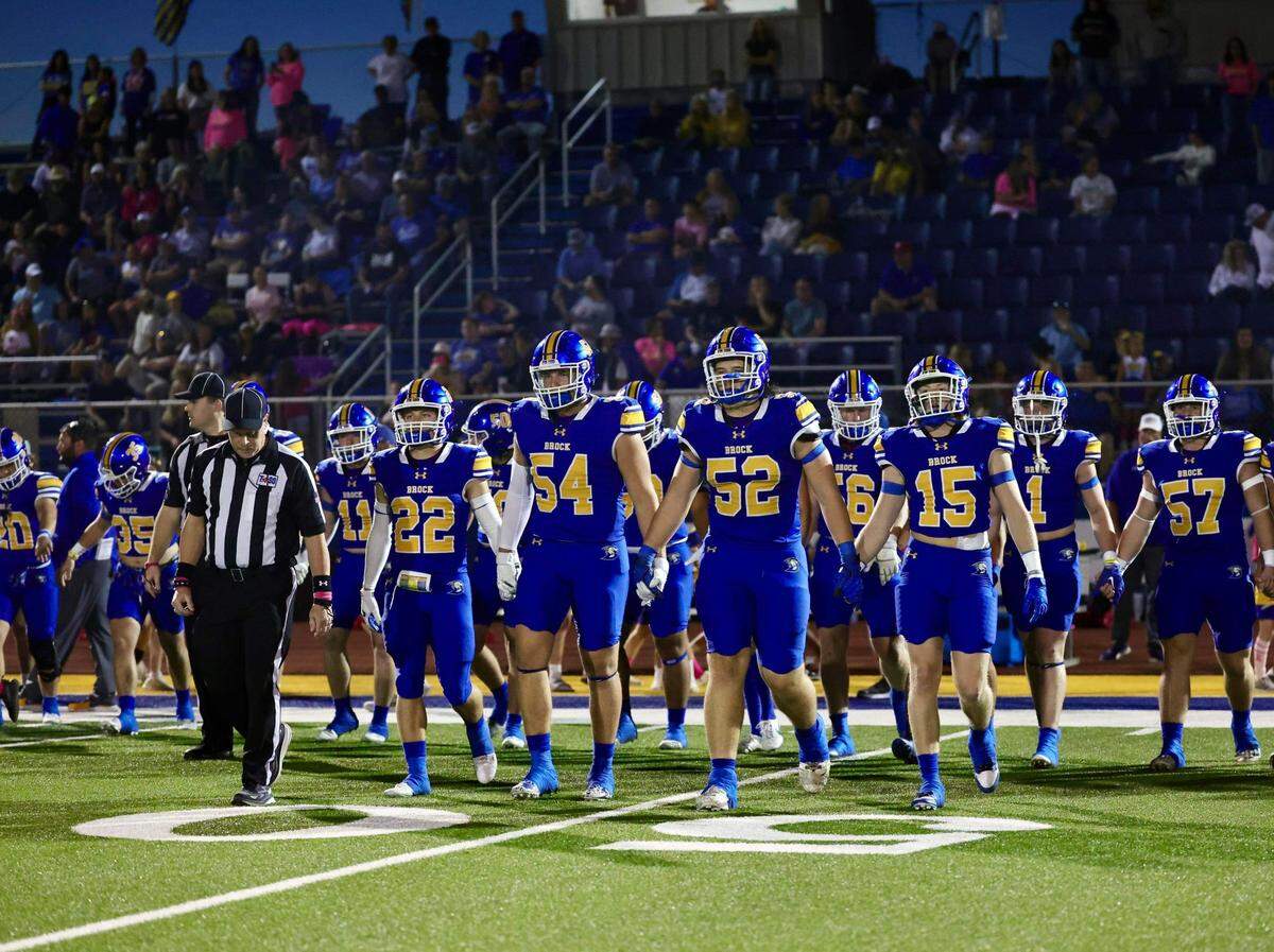 Brock captains Brett Tutter (22), Hunter Fay (54), Brock Riker (52) and Cooper Massey (15) walk out for the coin toss against Paradise on October 20, 2023 at Eagle Field in Brock, Texas.