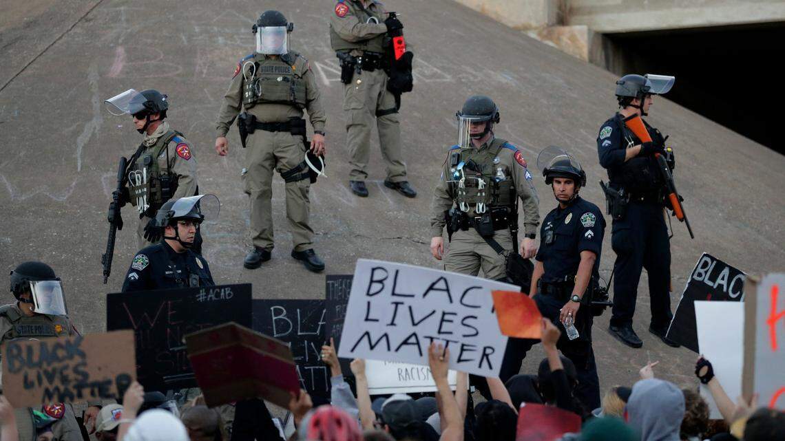 Demonstrators gathered in Austin, Texas, to protest the death of George Floyd as authorities control the crowd. This is not the protest where Justin Howell and Anthony Evans were each shot and injured by police. Howell and Evans received a combined $10 million settlement in response to their lawsuits.