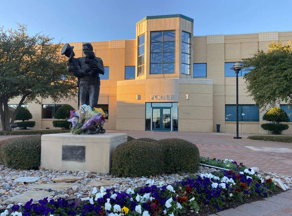 Euless police placed flowers on a memorial in front of their headquarters in memory of Detective Alejandro Cervantes, who was killed Saturday in a crash involving an accused drunken driver.
