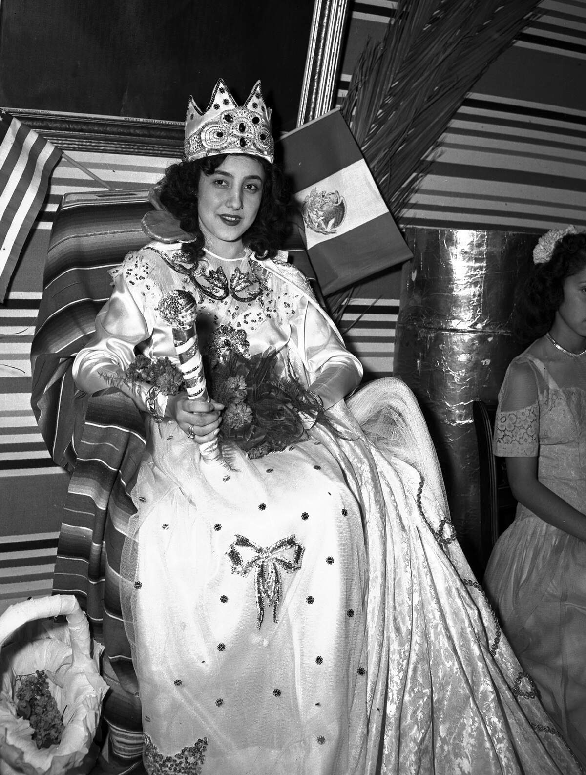 Sept. 15, 1946: “The Mexican Independence Day fiesta celebration is being held Sunday night in Fort Worth, Texas. Miss Raquel Rios is the reigning queen of the fiesta. She is shown sitting on her throne during the party. The Mexican and American flags are attached to her chair.