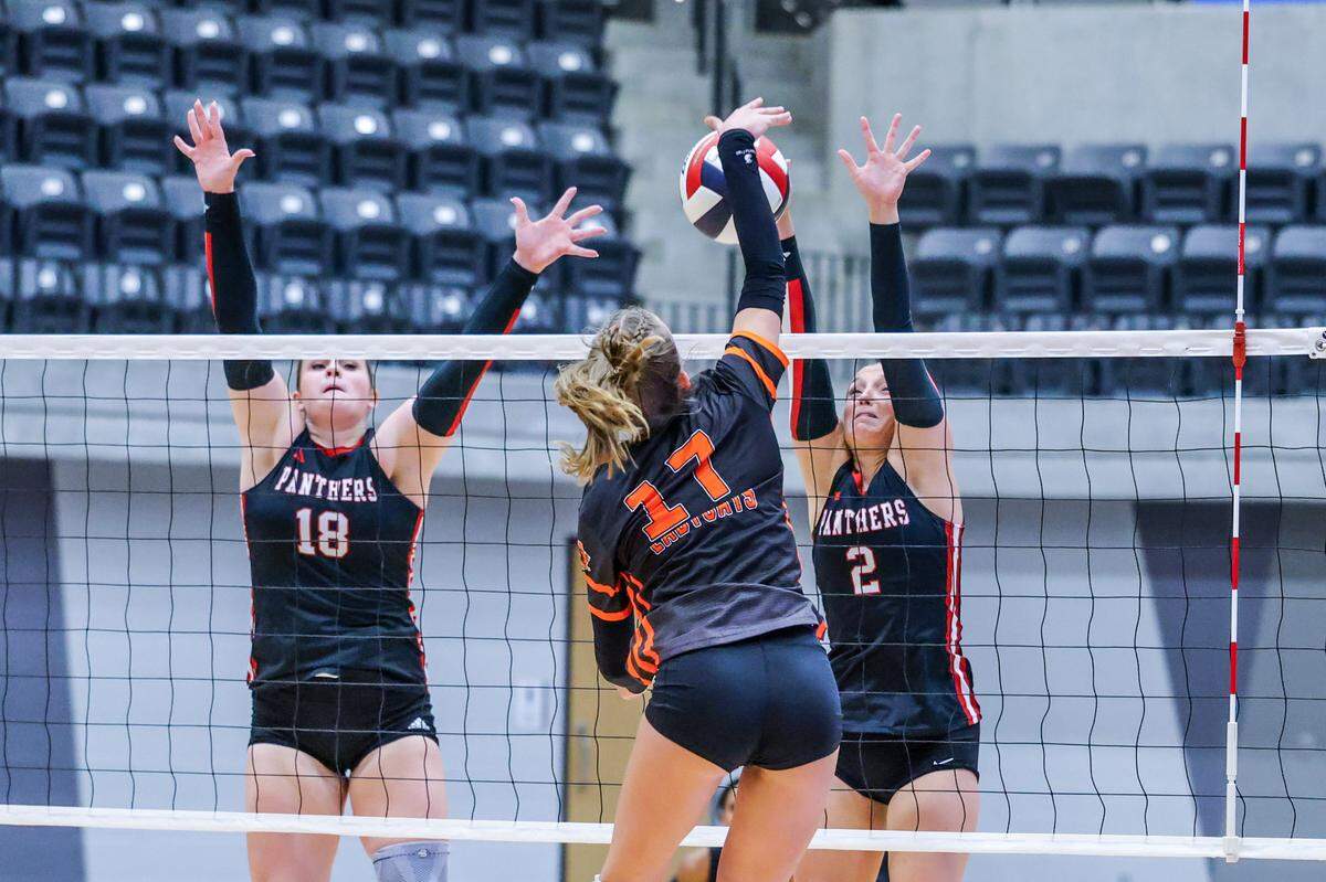 Aledo’s Brynlee Schneider (17) hits the ball as Colleyville Heritage players Mackenzie Carr (18) and Audrey Popp attempt to block it Thursday.