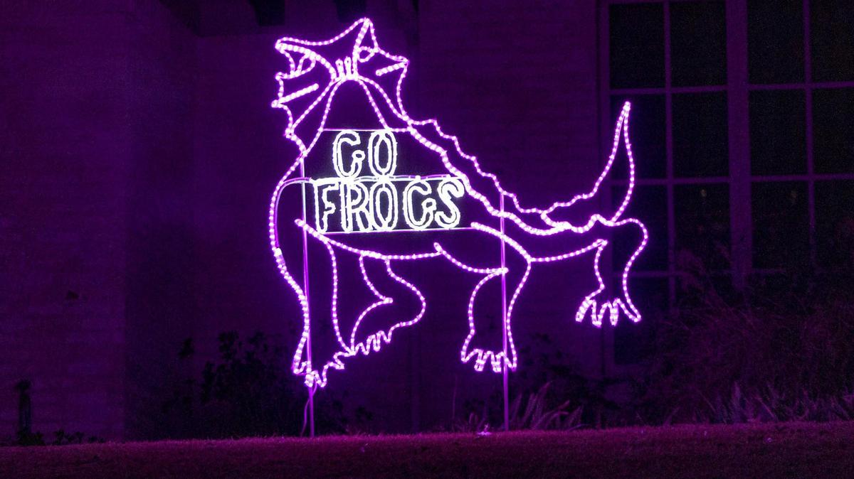 A home near the Texas Christian University campus is lit purple in Fort Worth on Wednesday, Jan. 4, 2023.