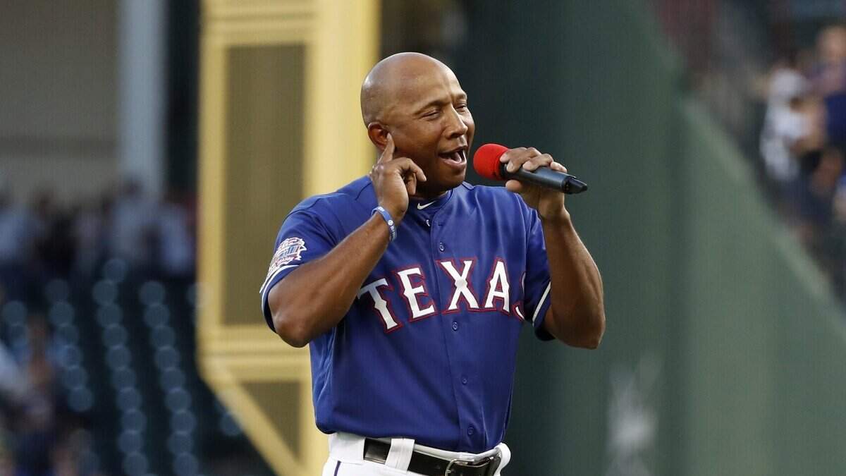 Rangers third-base coach Tony Beasley belts out a wonderful rendition of the Star-Spangled Banner before a game against the Yankees.