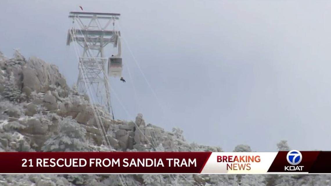 A stranded passenger rappels down from one of two trams stranded overnight on Sandia Peak in New Mexico by icy conditions on New Year’s Eve.