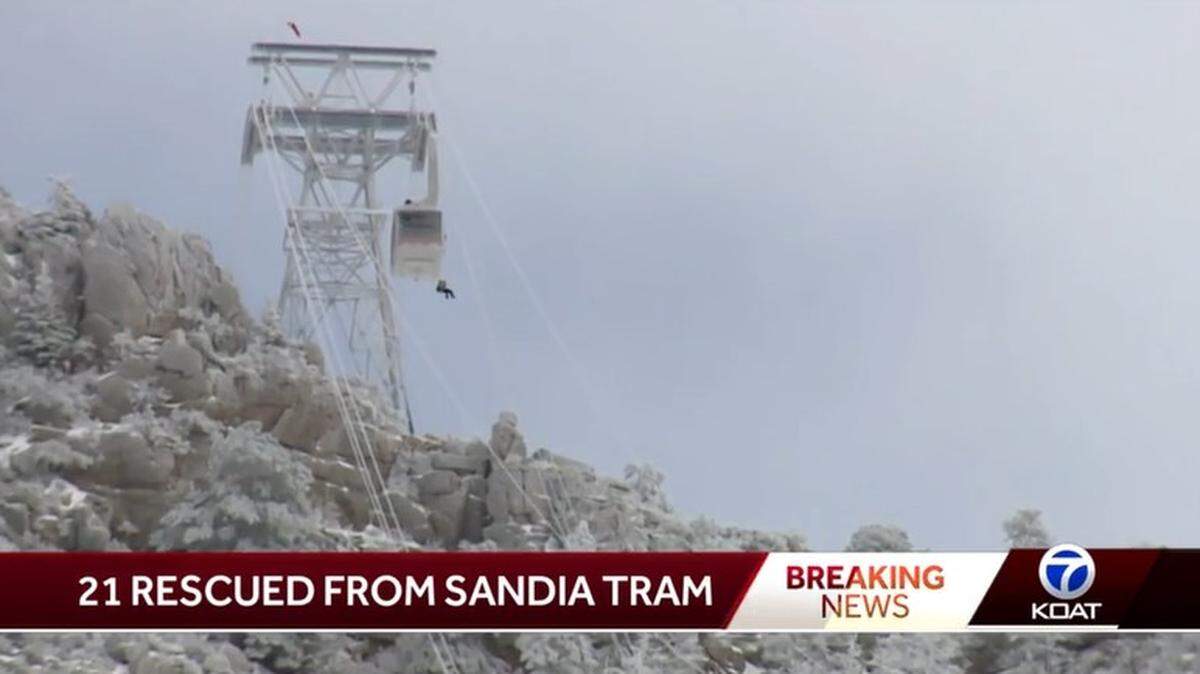 A stranded passenger rappels down from one of two trams stranded overnight on Sandia Peak in New Mexico by icy conditions on New Year’s Eve.